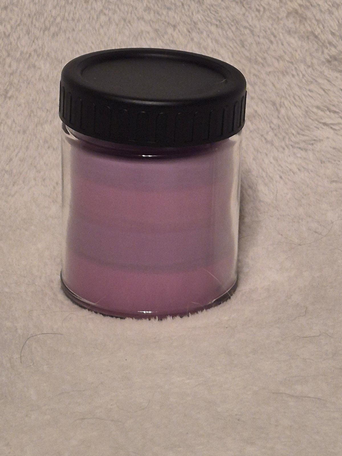 "Hand-poured Violet Voodoo scented candle 9oz with citrus, peach and floral notes"
