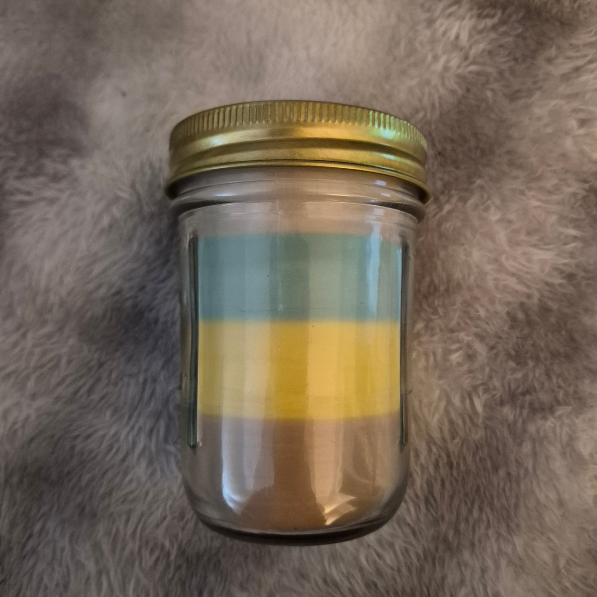 Top view of open 9oz Monkey Farts hand-poured candle in mason jar with wood wick, light green wax layers by Delightful Little Things"