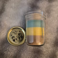 "9oz Monkey Farts scented handmade candle in glass jar with black lid, light green layered wax and Delightful Little Things Butt Naked label with penguin beach scene, DelightfulLittleThings.com"