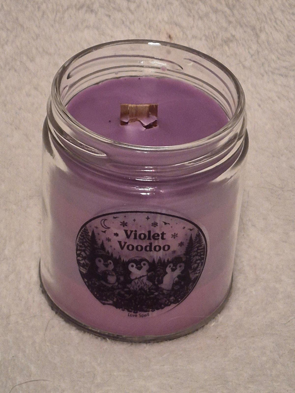 "Hand-poured Violet Voodoo scented candle 9oz with citrus, peach and floral notes"
